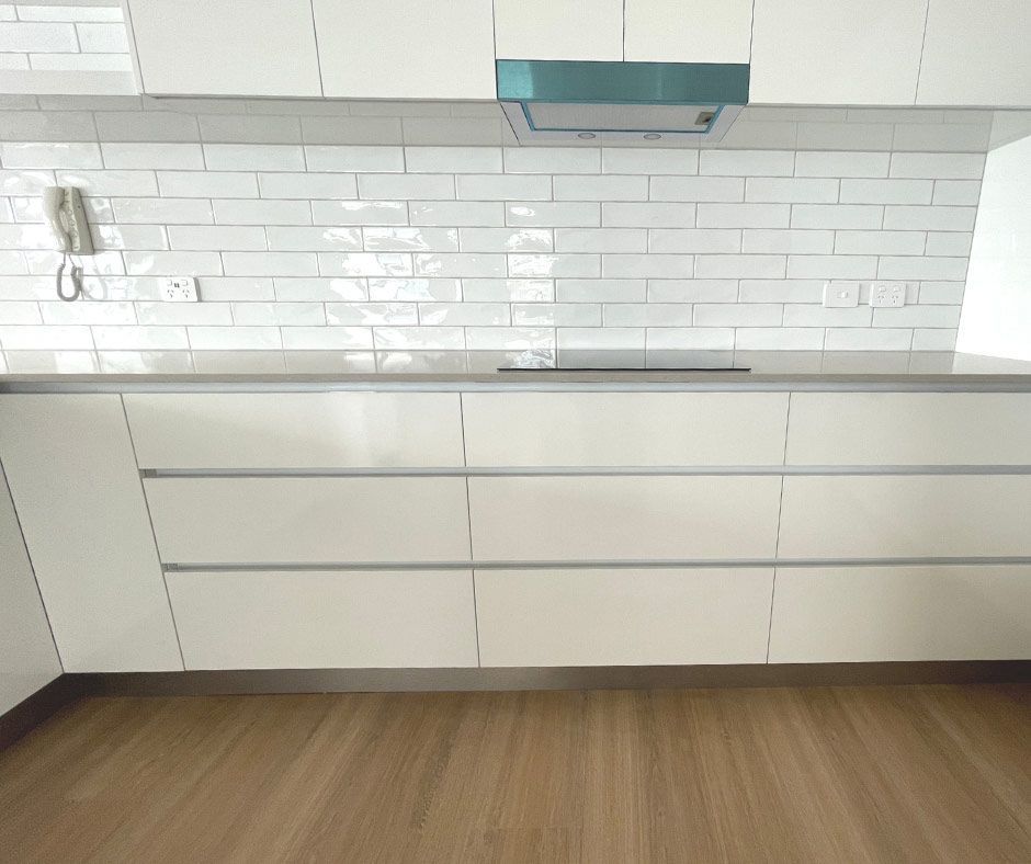 White Tiles And White Kitchen Cabinet — Nyblad Construction in Caloundra West, QLD