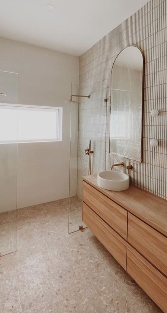 A Bathroom With A Wooden Cabinet And A Glass Screen Separating The Shower Area — Nyblad Construction in Caloundra West, QLD