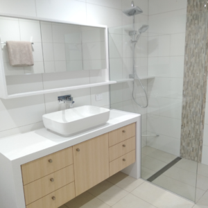 Bathroom With Mirror Shaving Cabinets — Nyblad Construction in Caloundra West, QLD
