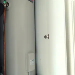 Two Water Heaters Are Sitting Next To Each Other On A Wall — Nyblad Construction in Caloundra West, QLD