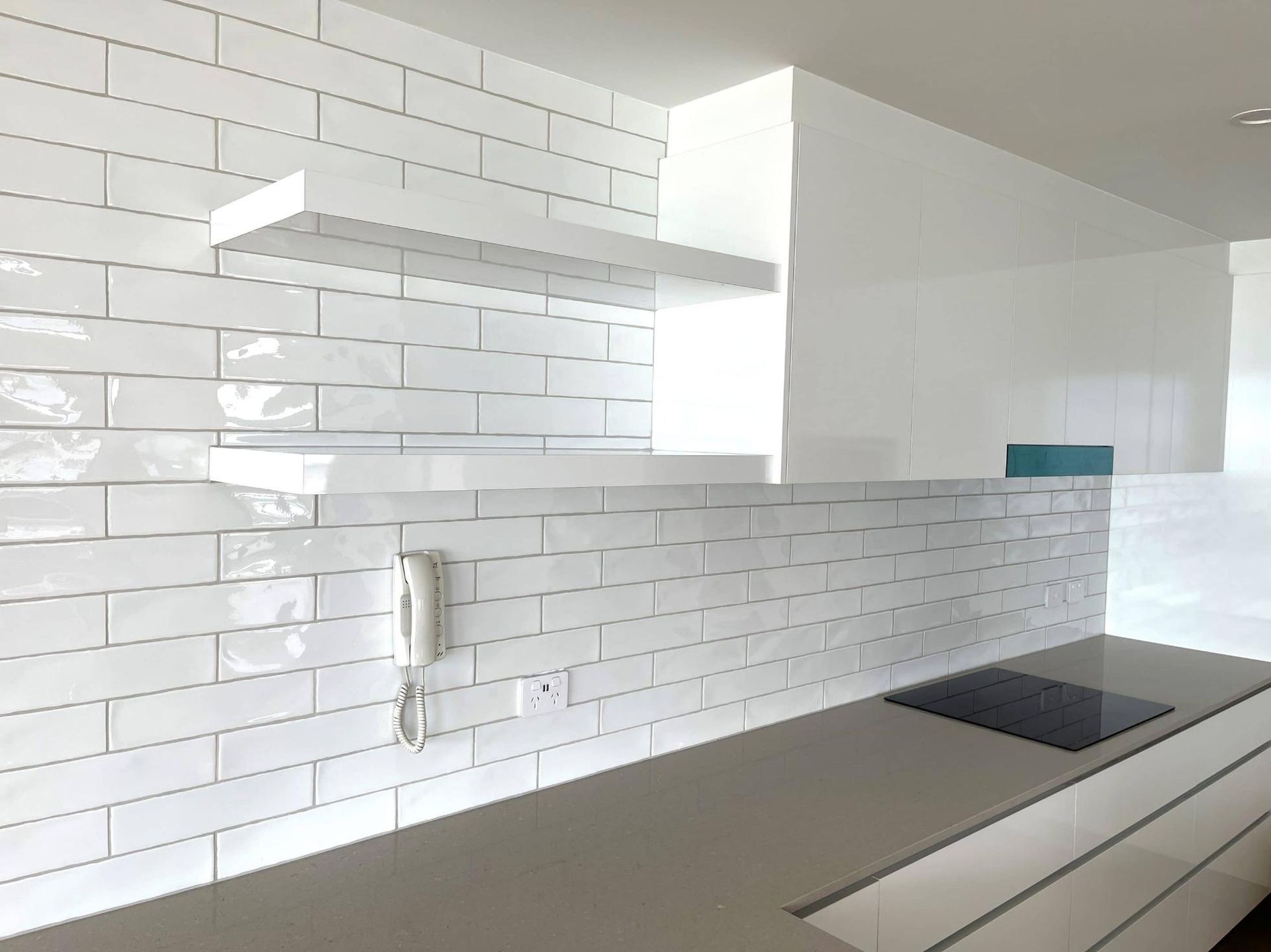 Kitchen With White Tiles and a Stove Top Oven — Nyblad Construction in Caloundra West, QLD