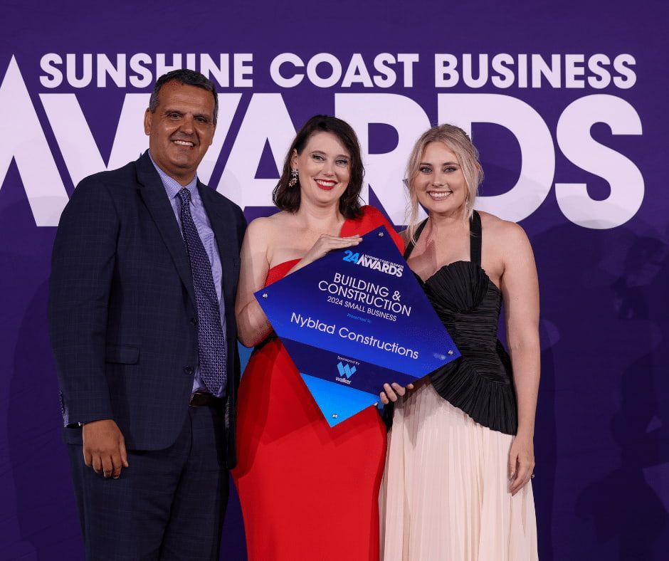 A Group of People Standing Next to Each Other — Nyblad Construction in Caloundra West, QLD