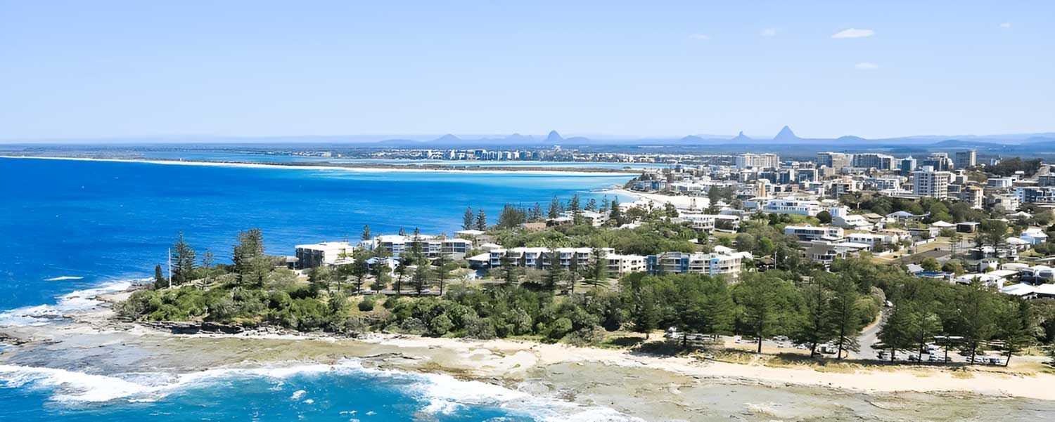 An Aerial View Of A City Next To A Body Of Water — Nyblad Construction in Caloundra West, QLD
