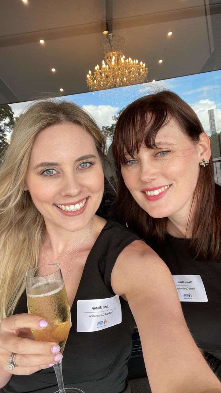 Two Women Are Taking A Selfie With A Glass Of Champagne — Nyblad Construction in Caloundra West, QLD