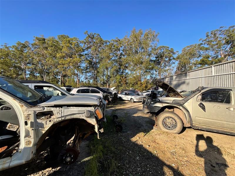 A Bunch Of Cars Are Parked In A Lot With Trees In The Background — Bago Auto Dismantlers in Wauchope, NSW