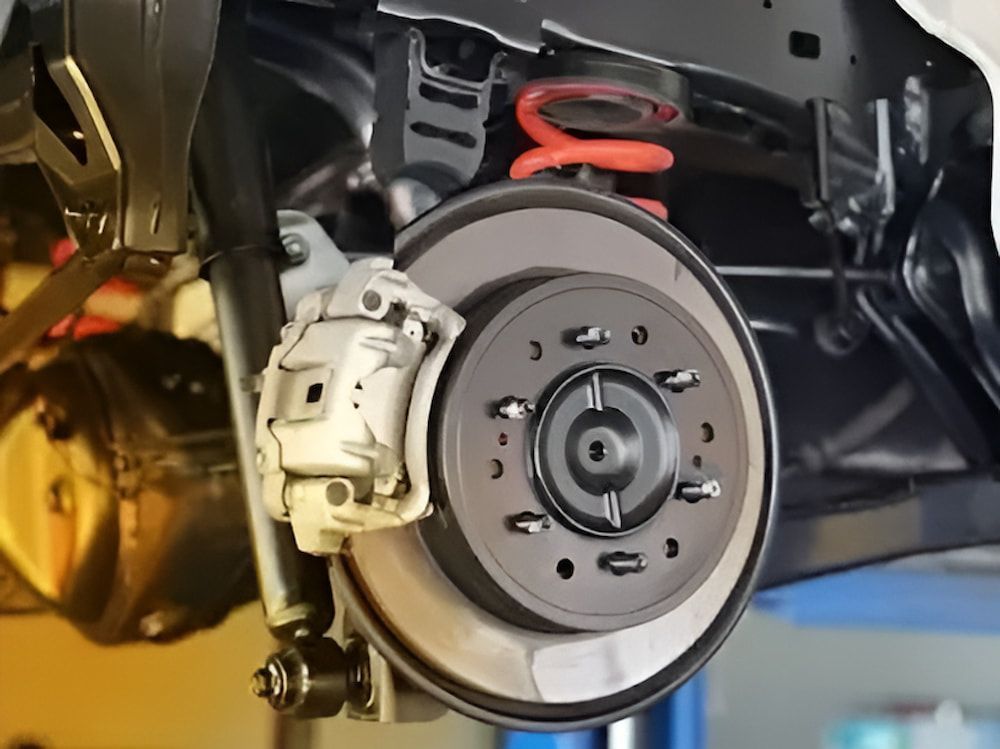 A Car's Brake System on a Lift — Bago Auto Dismantlers in Bonny Hills, NSW