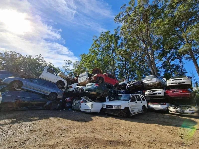 A Pile Of Cars Are Stacked On Top Of Each Other In A Junkyard — Bago Auto Dismantlers in Wauchope, NSW