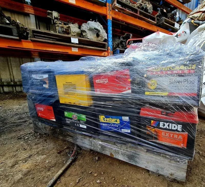 A Bunch Of Batteries Are Wrapped In Plastic And Sitting On Top Of A Pallet — Bago Auto Dismantlers in Laurieton, NSW