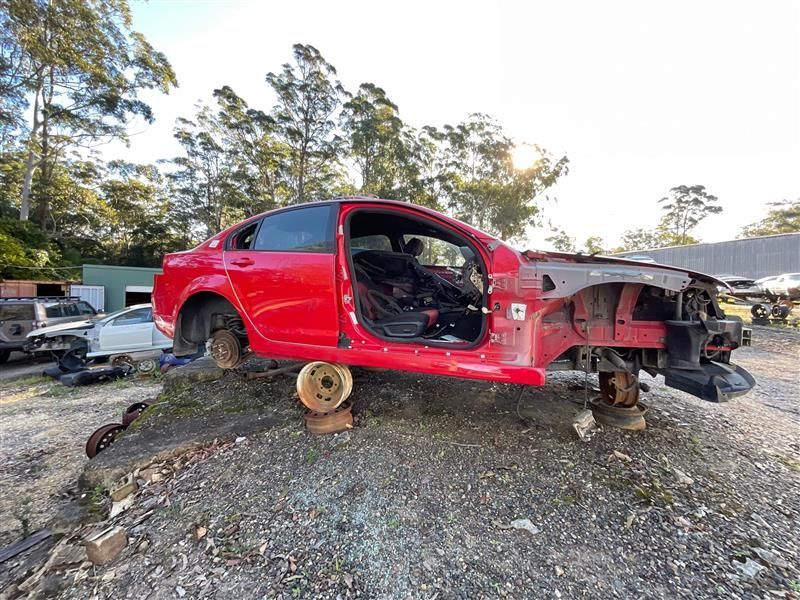 A Red Car Is Sitting On Top Of A Pile Of Gravel — Bago Auto Dismantlers in Lake Cathie, NSW