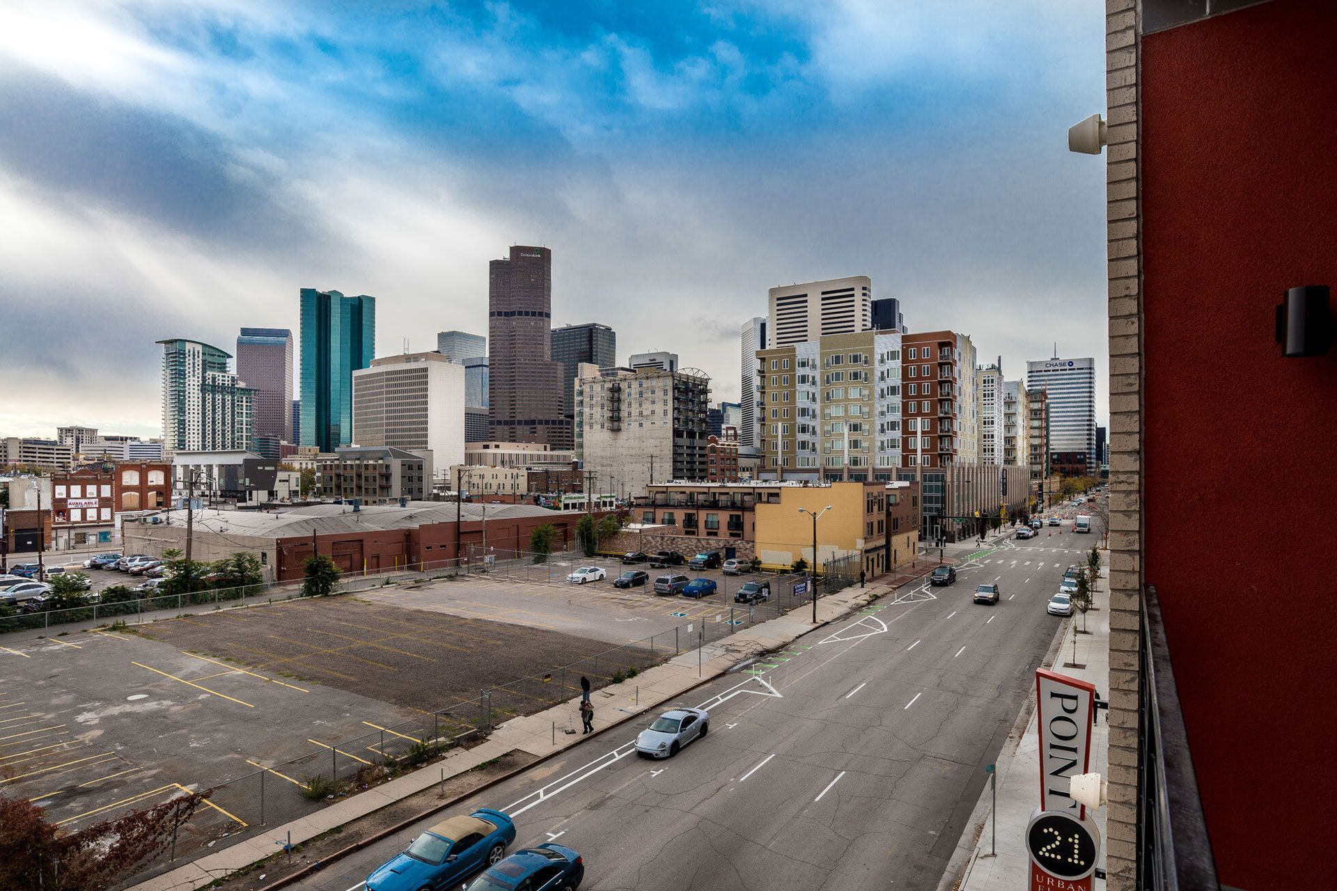 View of downtown skyline from a balcony of a multifamily building.