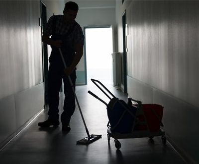 Avalanche Commercial Cleaning - Man With Broom Cleaning Office Corridor, USA