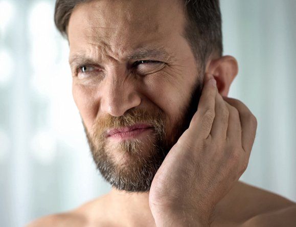 Man Holding His Ear — Rose Hill, KS — Rose Hill Chiropractic