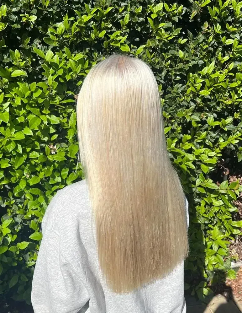 Woman's Long, Wavy, Blonde Hair After a Salon Visit — Elysian Salon In Wyong, NSW