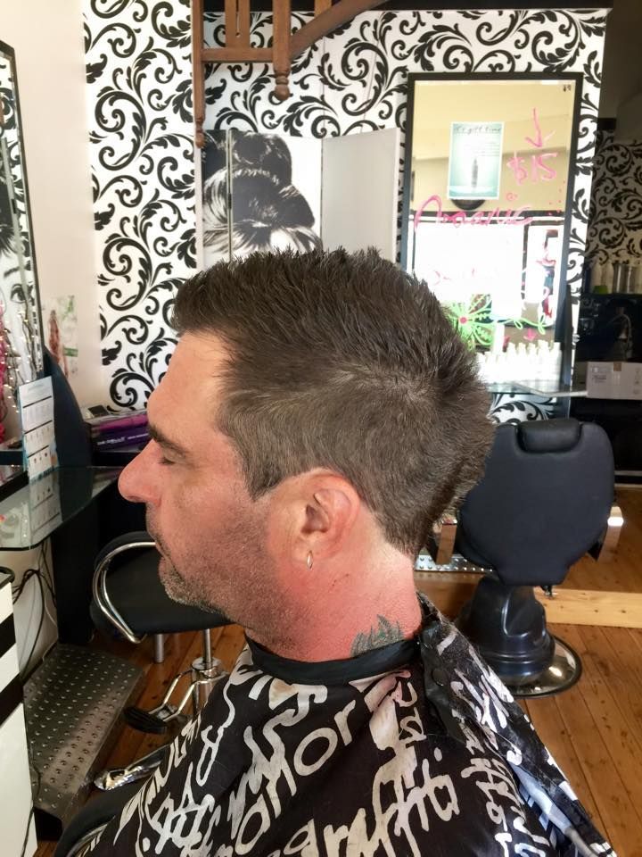 A Man is Getting His Hair Cut in a Salon — Choo Choo Hair and Beauty In Wyong, NSW