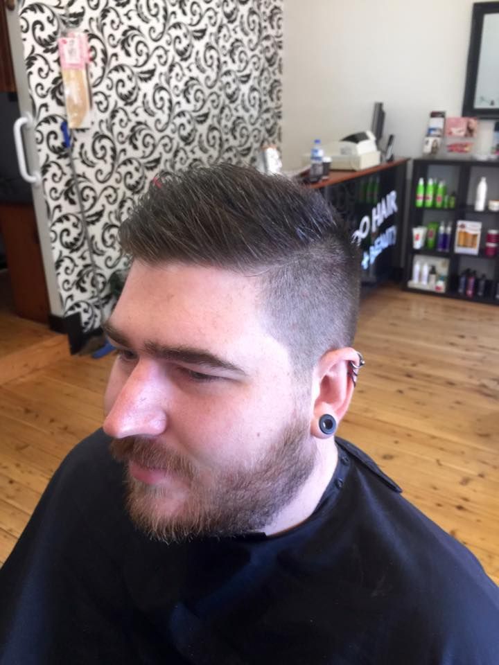 A Man With a Beard is Getting His Hair Cut at a Barber Shop — Choo Choo Hair and Beauty In Wyong, NSW