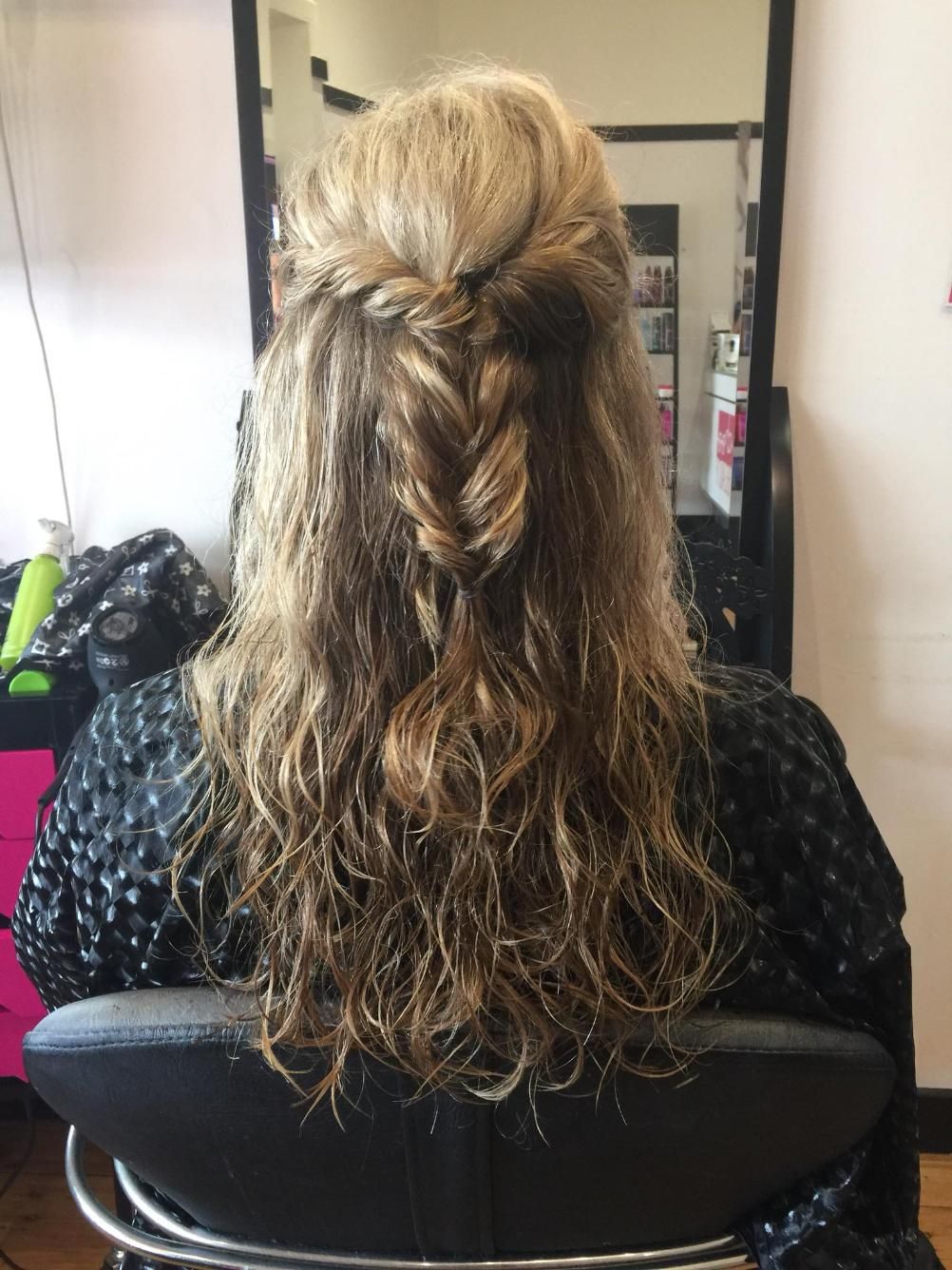 A Woman is Sitting in a Chair With Her Hair in a Half Up Half Down Braid — Choo Choo Hair and Beauty In Wyong, NSW