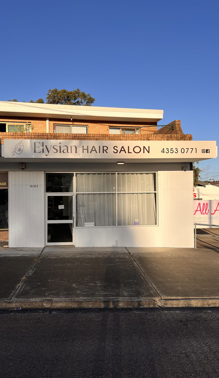 A Woman With Purple and Blue Hair is Reflected in a Mirror — Elysian Salon In Wyong, NSW