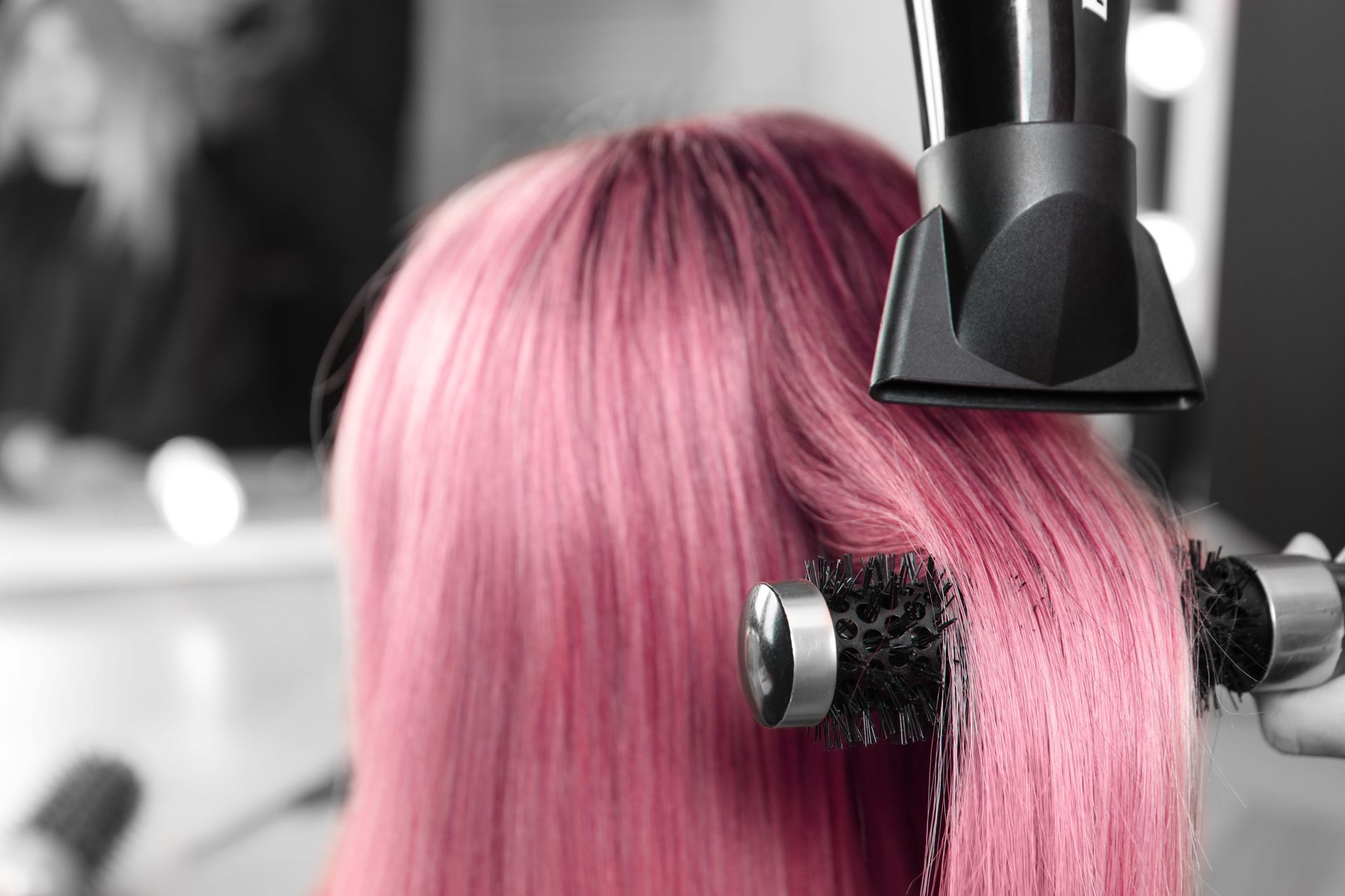A Woman is Getting Her Hair Blow Dried by a Hairdresser — Choo Choo Hair and Beauty In Wyong, NSW