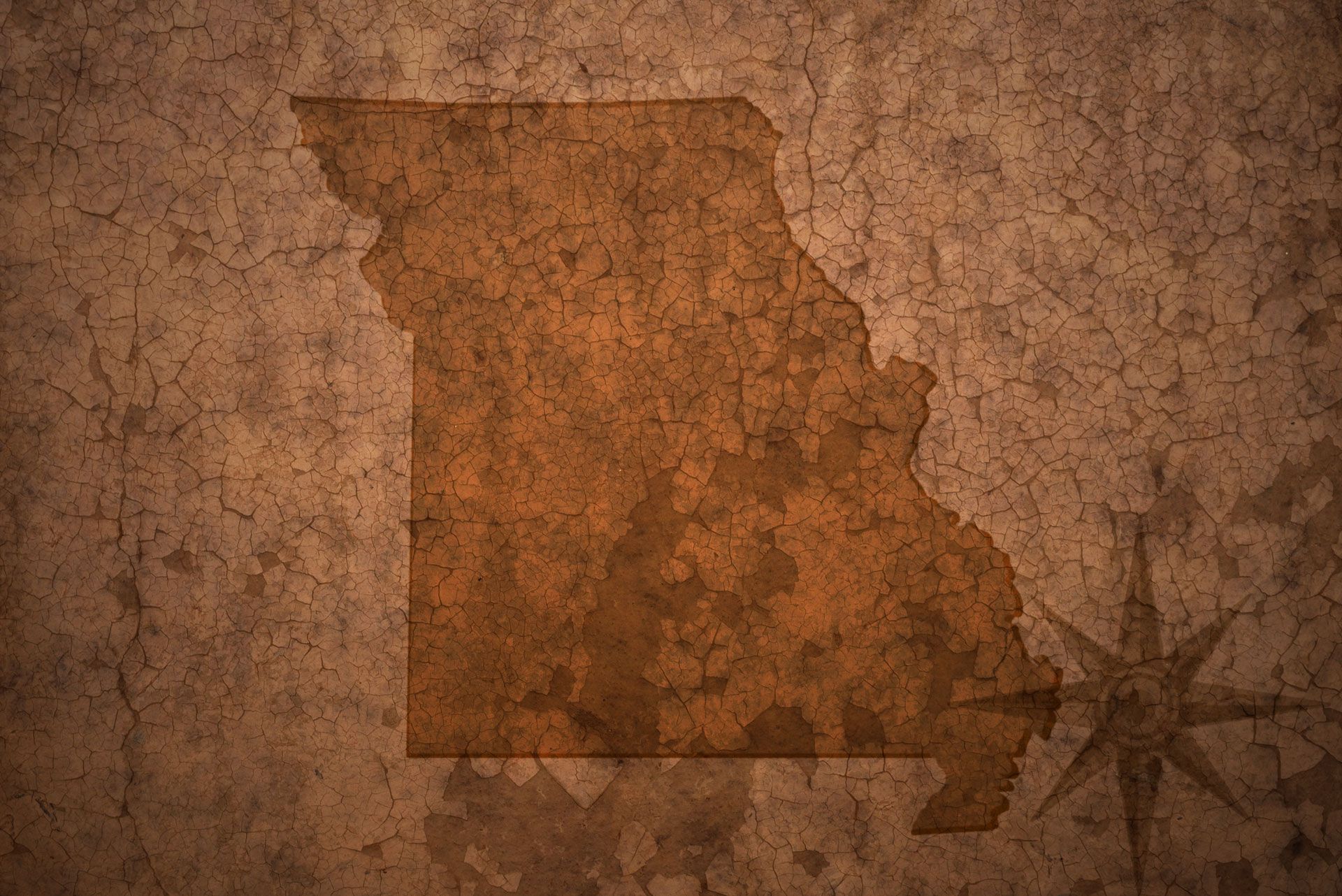 Map of Missouri in brown on a textured background with a compass rose.