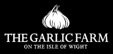 White logo for The Garlic Farm on the Isle of Wight featuring a stylized garlic bulb illustration on a black background.