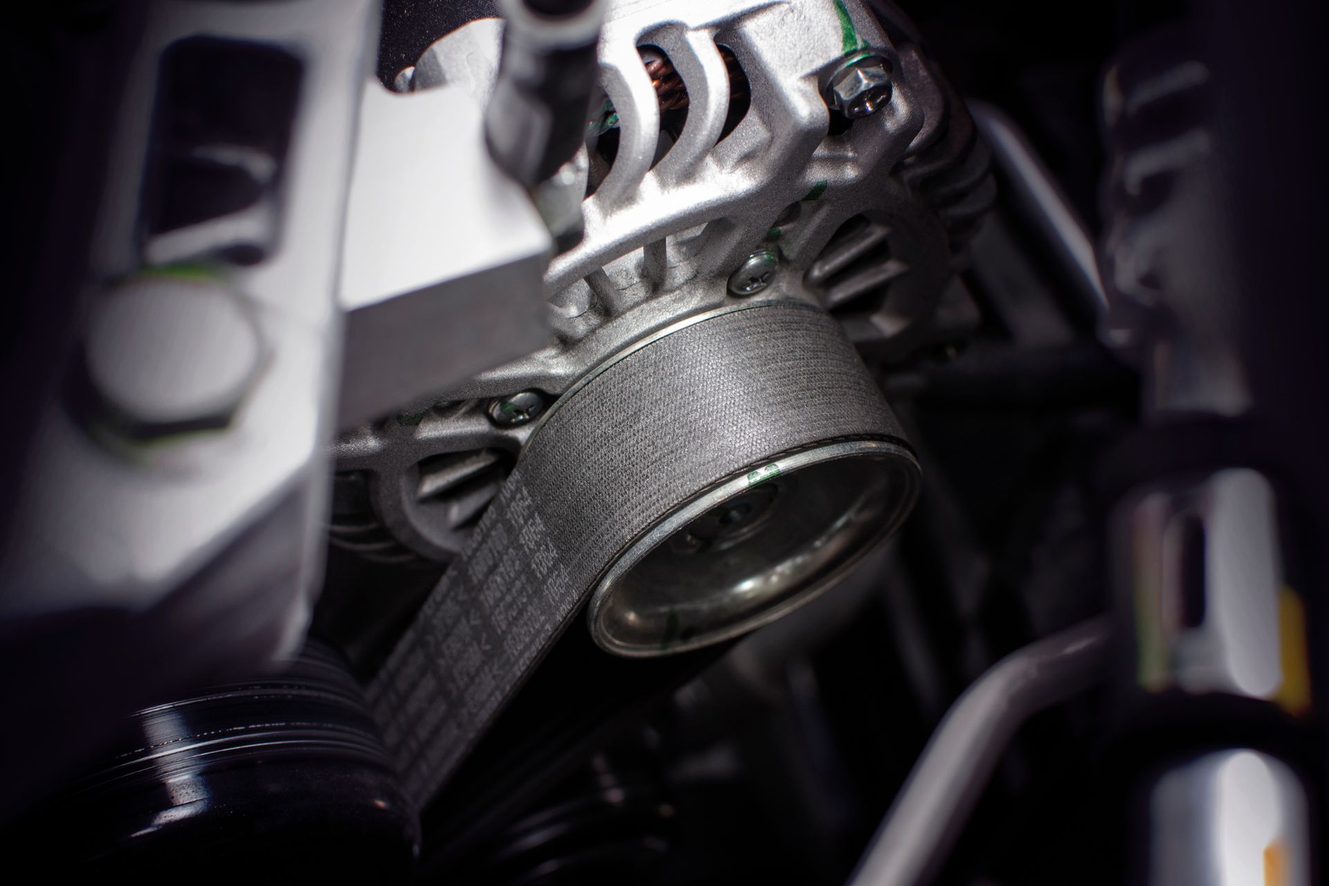 A close up of a belt on a car engine.