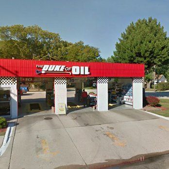 A red and white gas station called the duke of oil