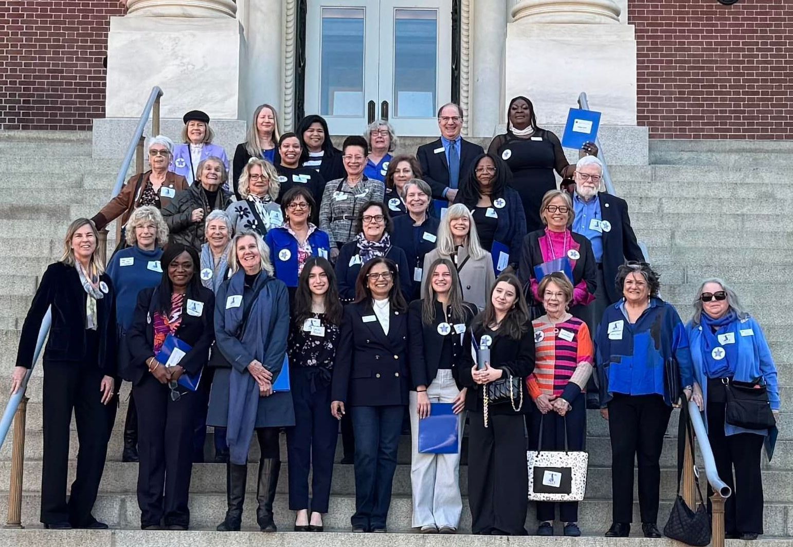 A group of WDC Members are posing for a picture on the steps of Annapolis Capital building.