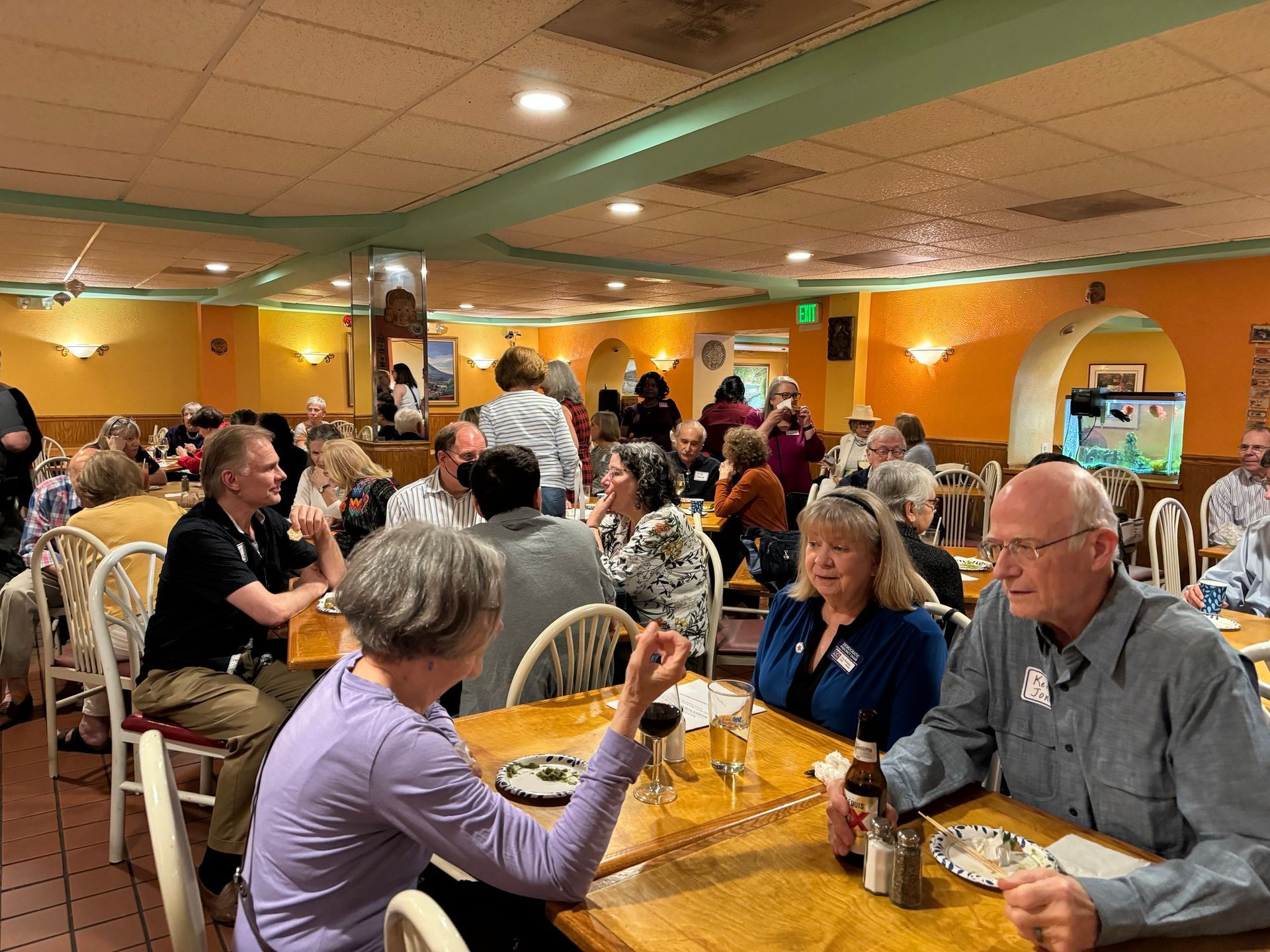 Happy Hour with a Purpose event, eating and talking in a brightly-colored Mexican restaurant.