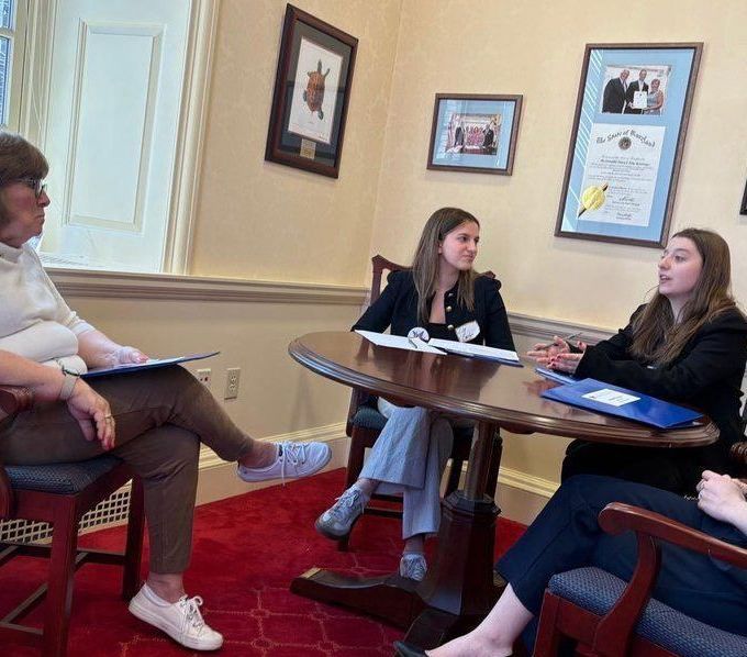 Four WDC members in a room with a table. 