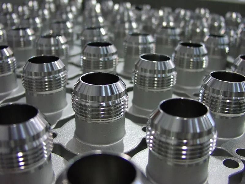 Exposed electrical wires emerging from a metal conduit, taped together, lying on a surface.