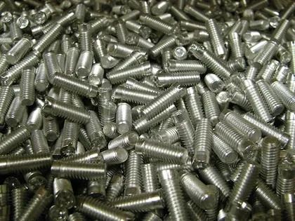 Exposed electrical wires emerging from a metal conduit, taped together, lying on a surface.