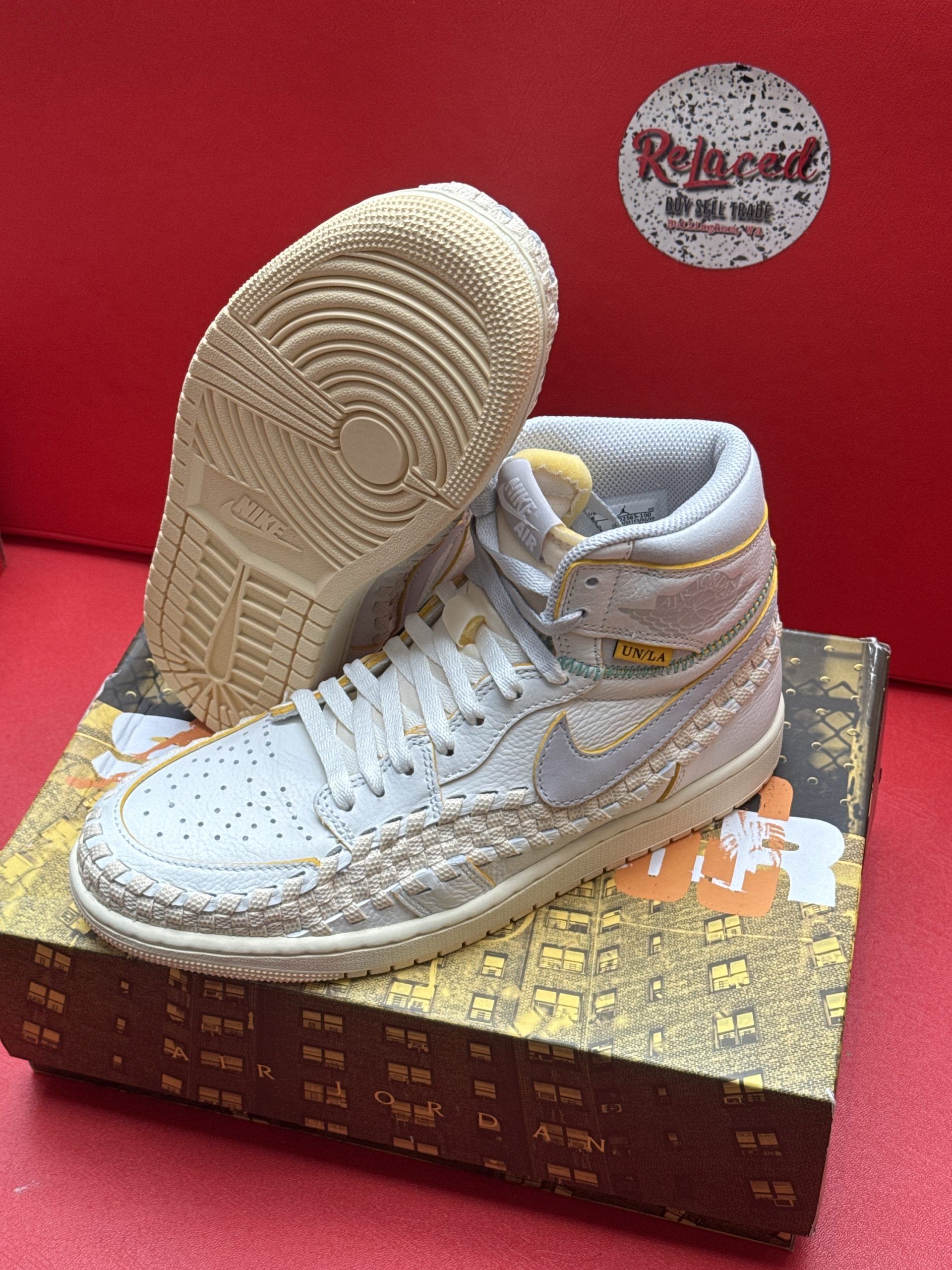 Light blue and yellow high-top sneakers with textured detailing, atop a patterned shoebox.