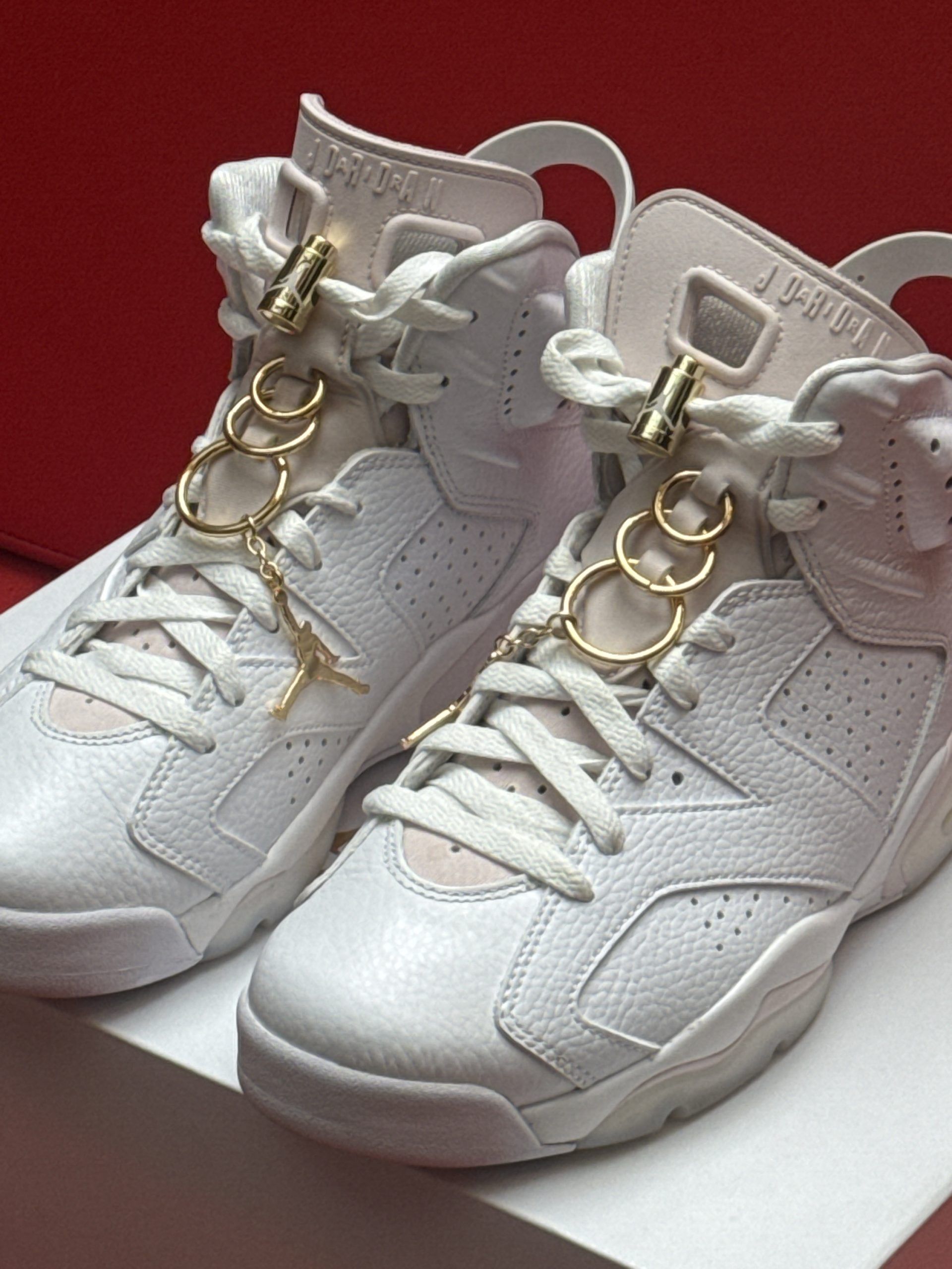White Air Jordan 6 sneakers on a white box, set against a red background.