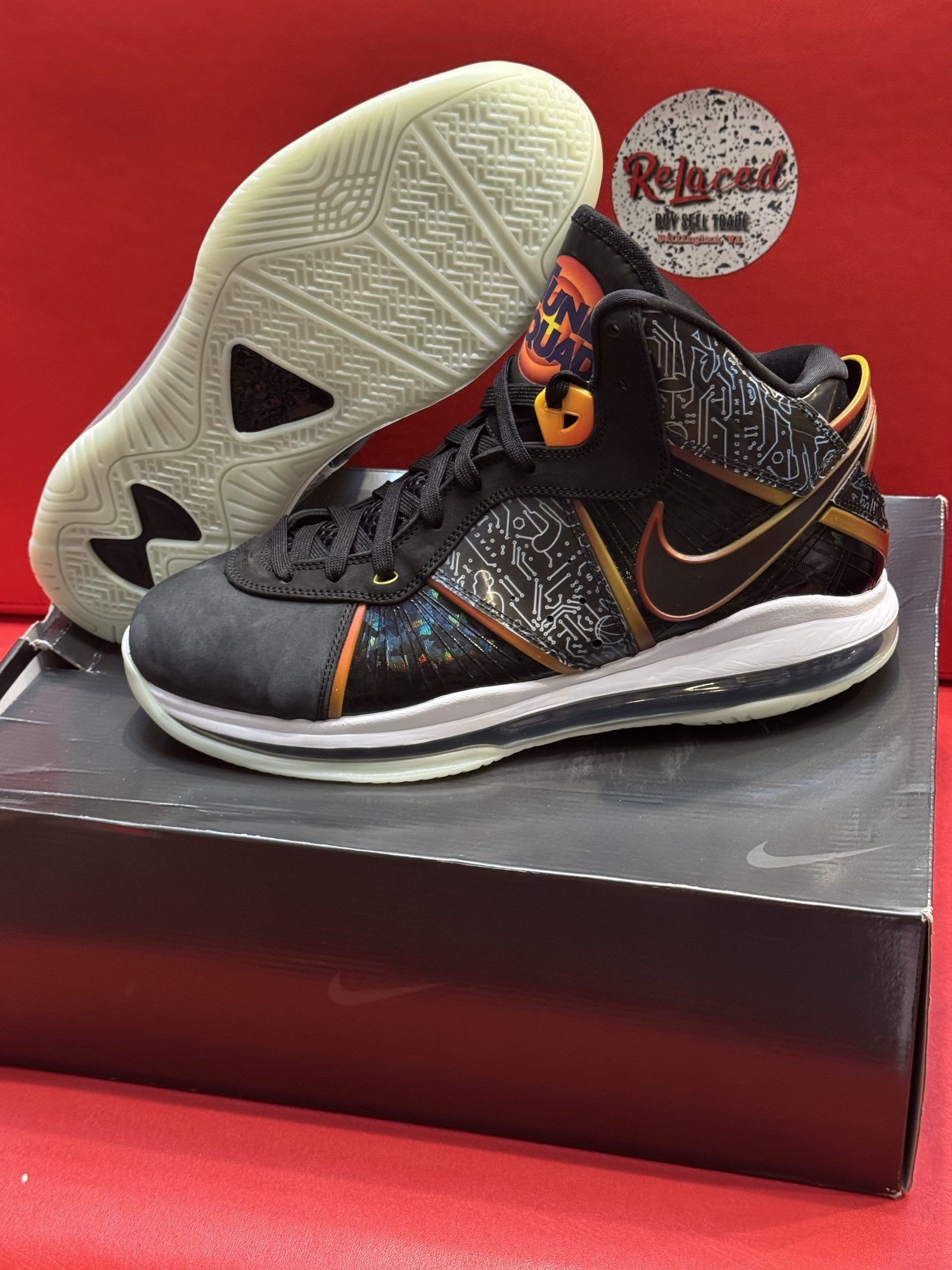 Black and gold Nike LeBron 8 sneakers on a shoebox.