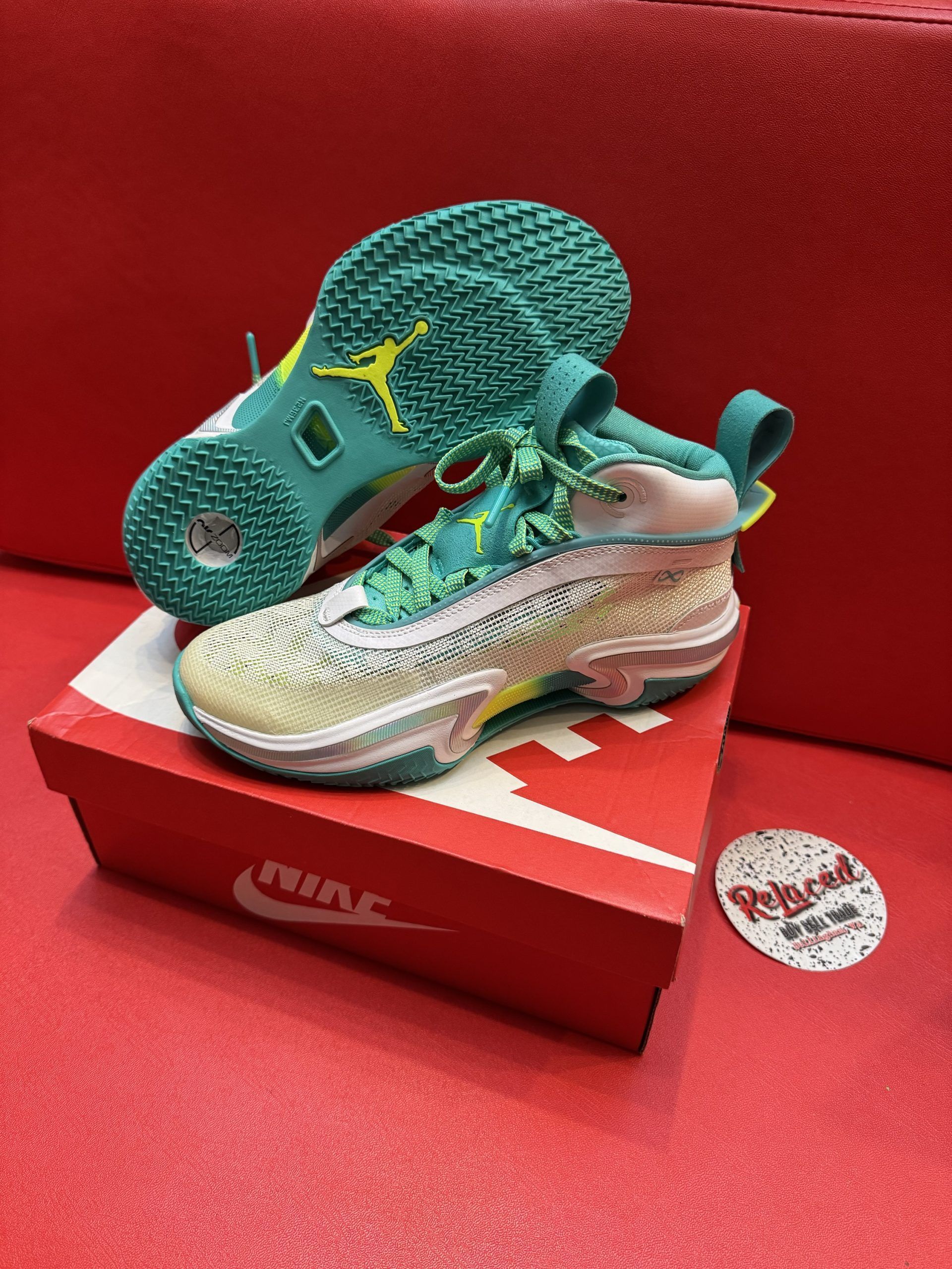Jordan 36 sneakers on a red Nike box, green and white colors.