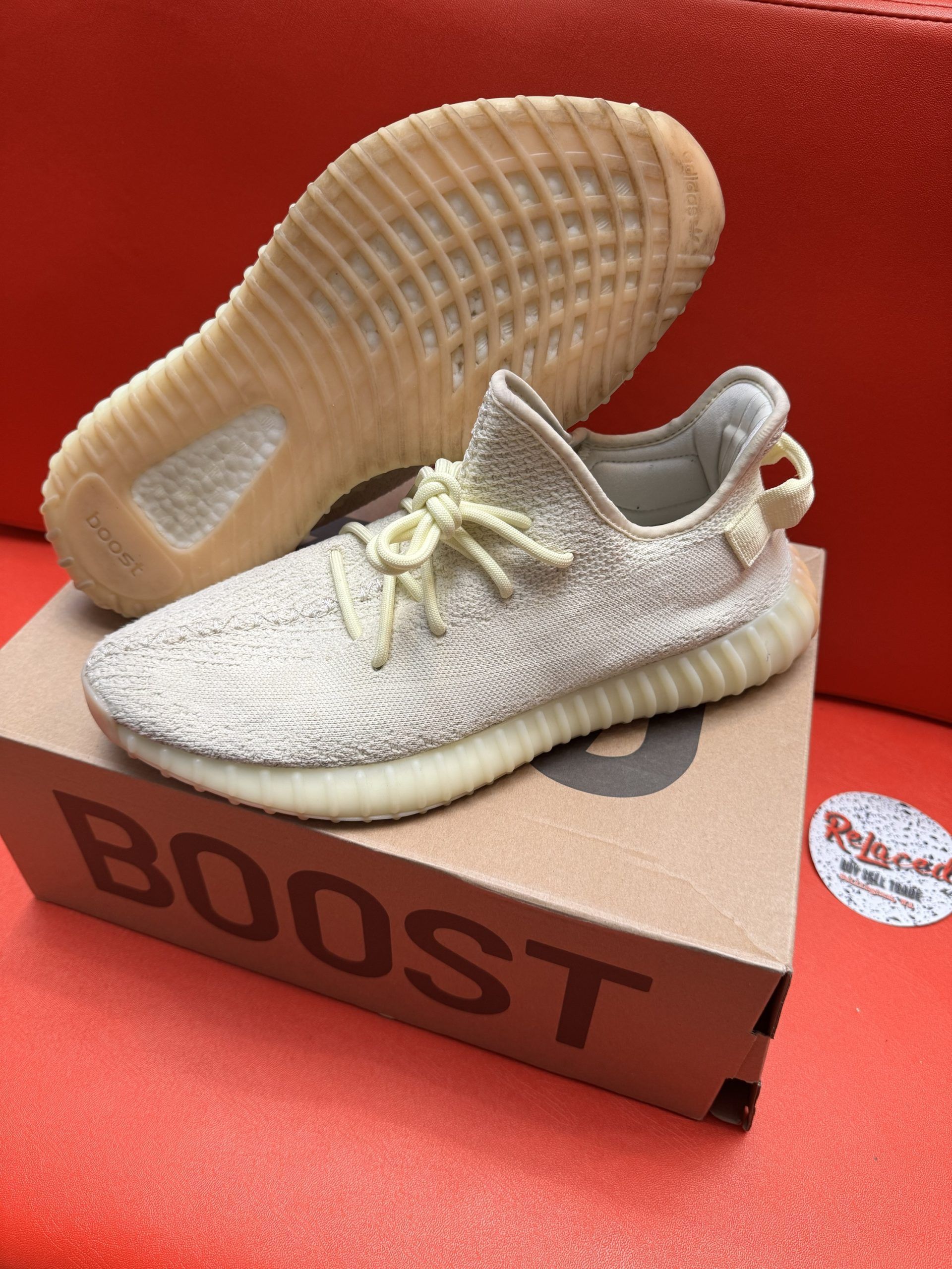 Tan Adidas Yeezy Boost 350 V2 sneakers on box, showing sole.