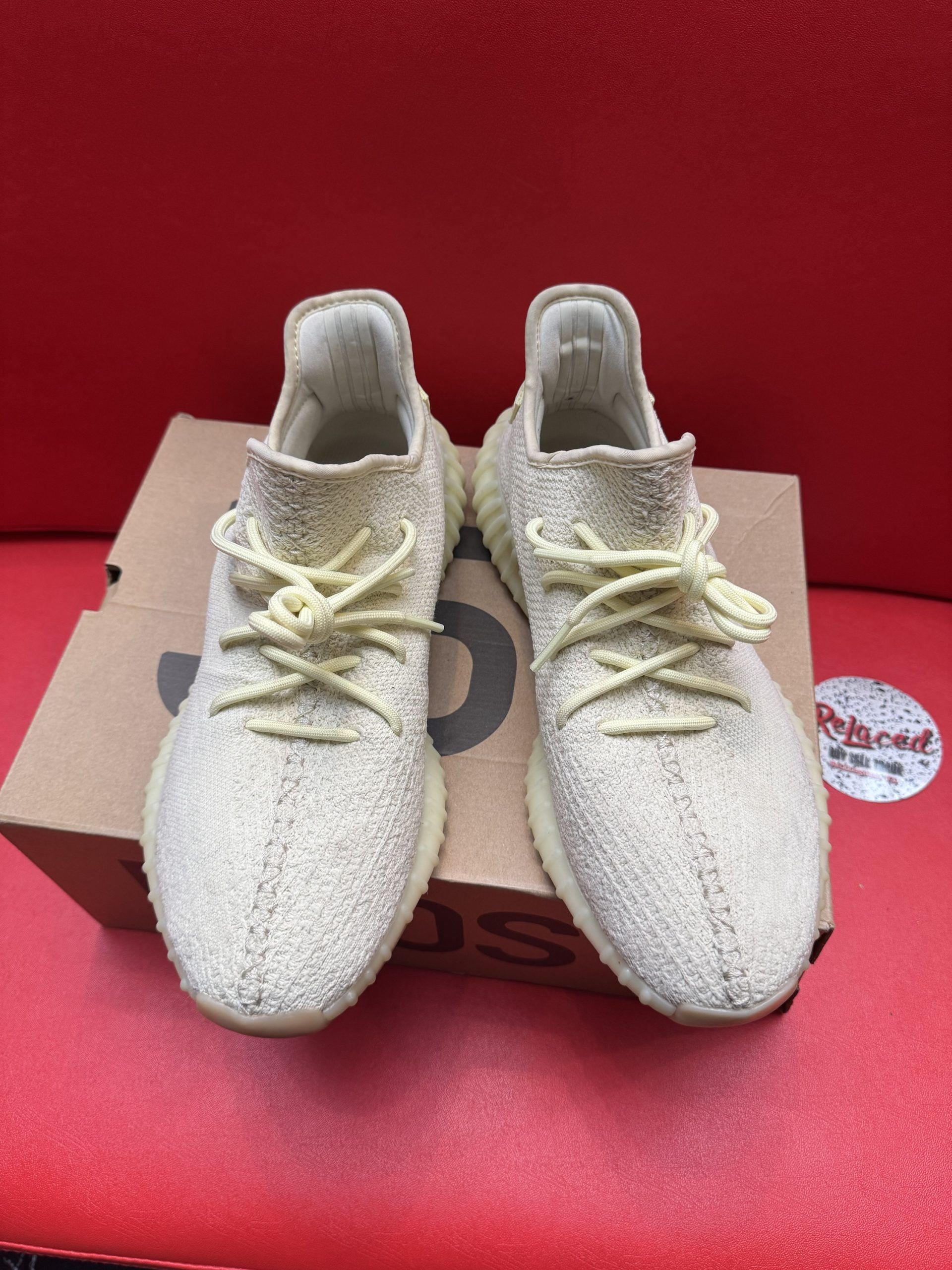 Tan Adidas Yeezy Boost 350 V2 sneakers on box, showing sole.