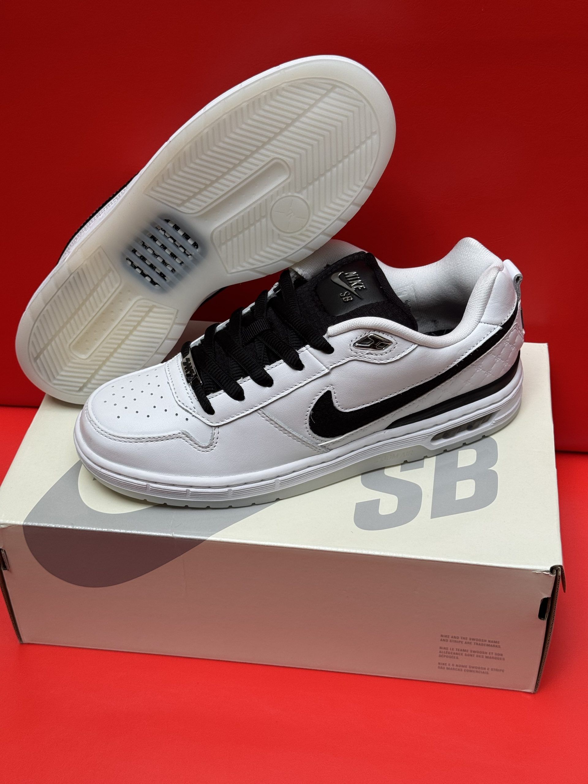 White Nike SB sneakers with black accents on box, sole visible.