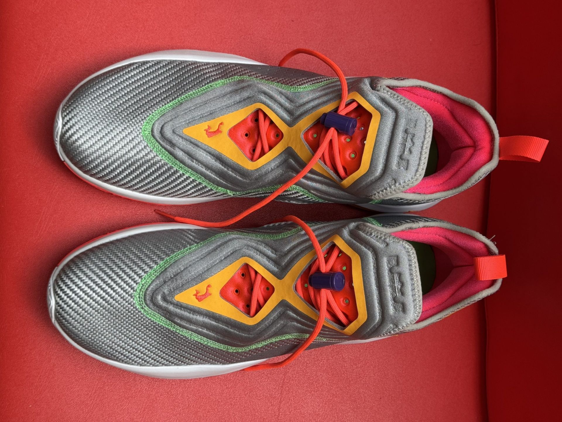 Gray, orange, and red athletic shoes. 