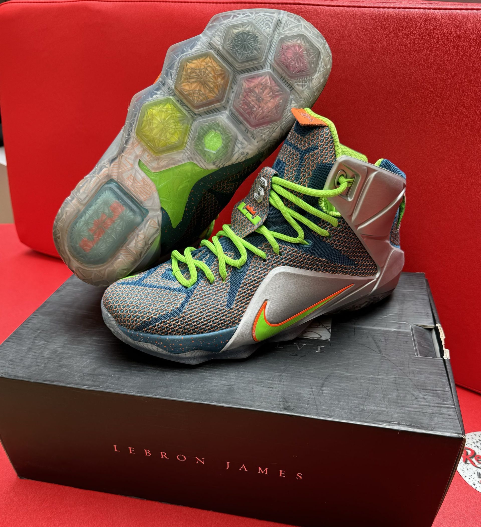 LeBron James Nike basketball shoes on box; multi-colored soles and neon green laces.
