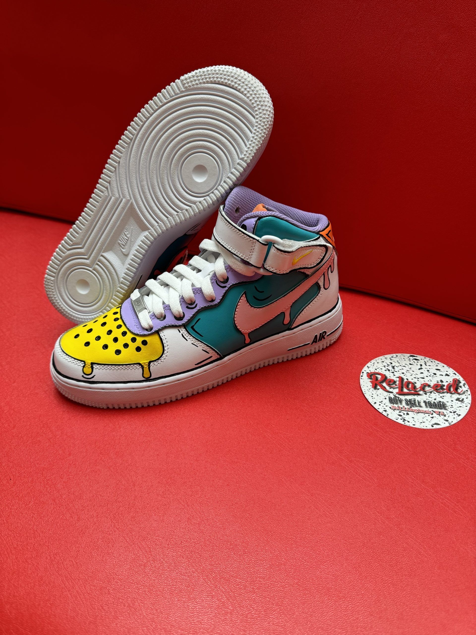 Customized Nike Air Force 1 sneaker in a colorful ice cream design on a red surface.