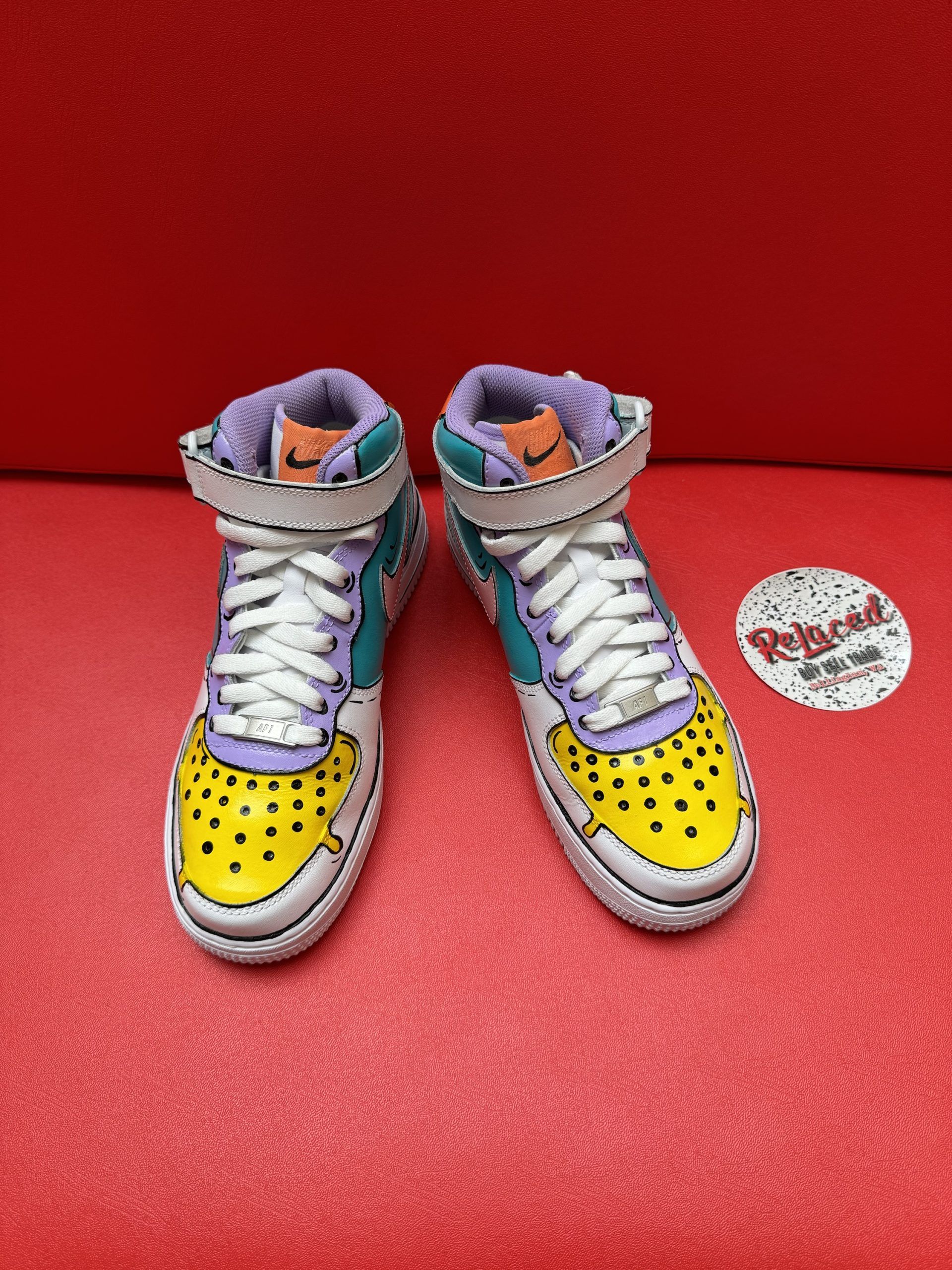Customized Nike Air Force 1 sneaker in a colorful ice cream design on a red surface.