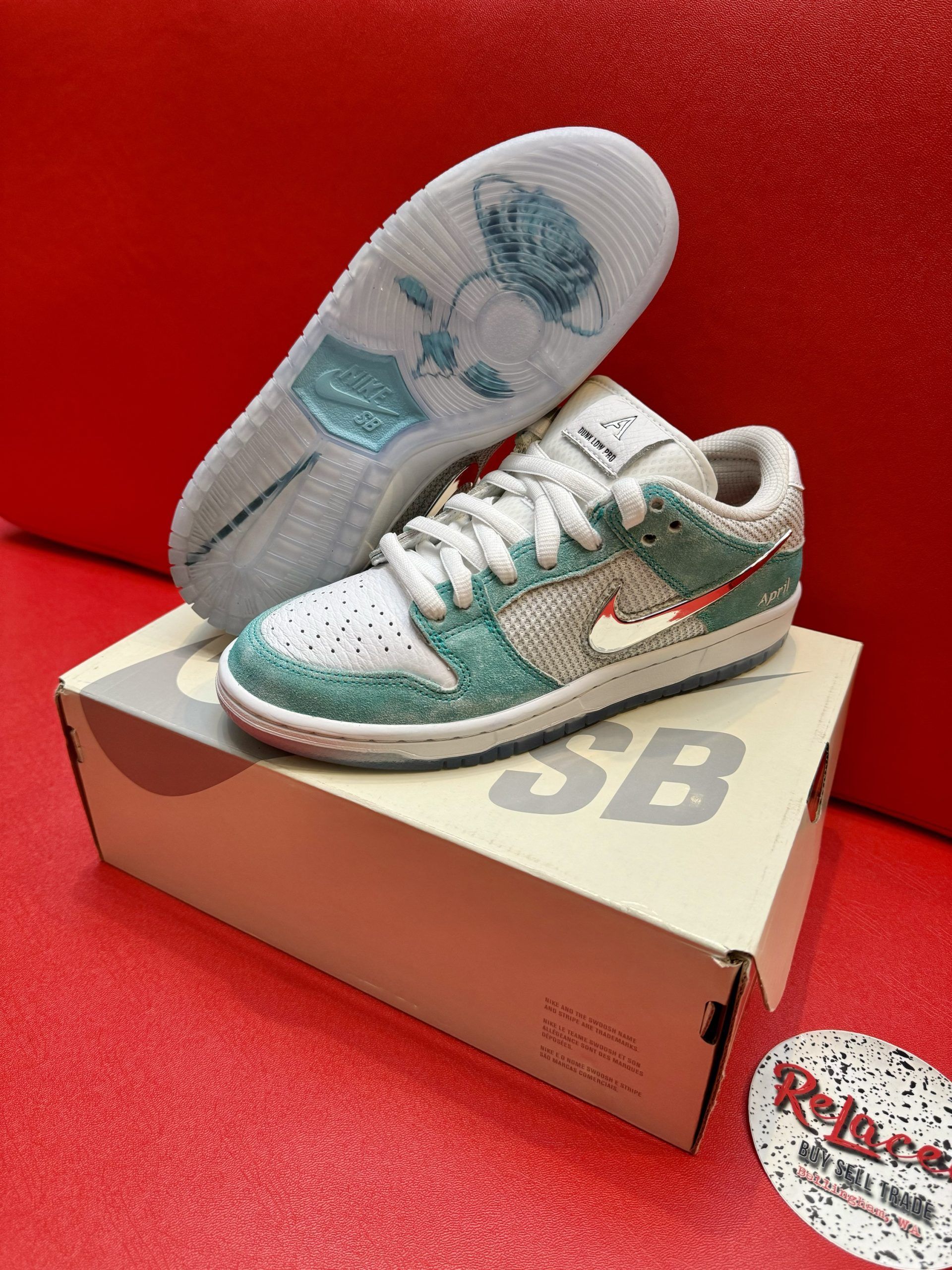 Nike SB Dunk Low sneakers with blue and white accents, on a shoe box.
