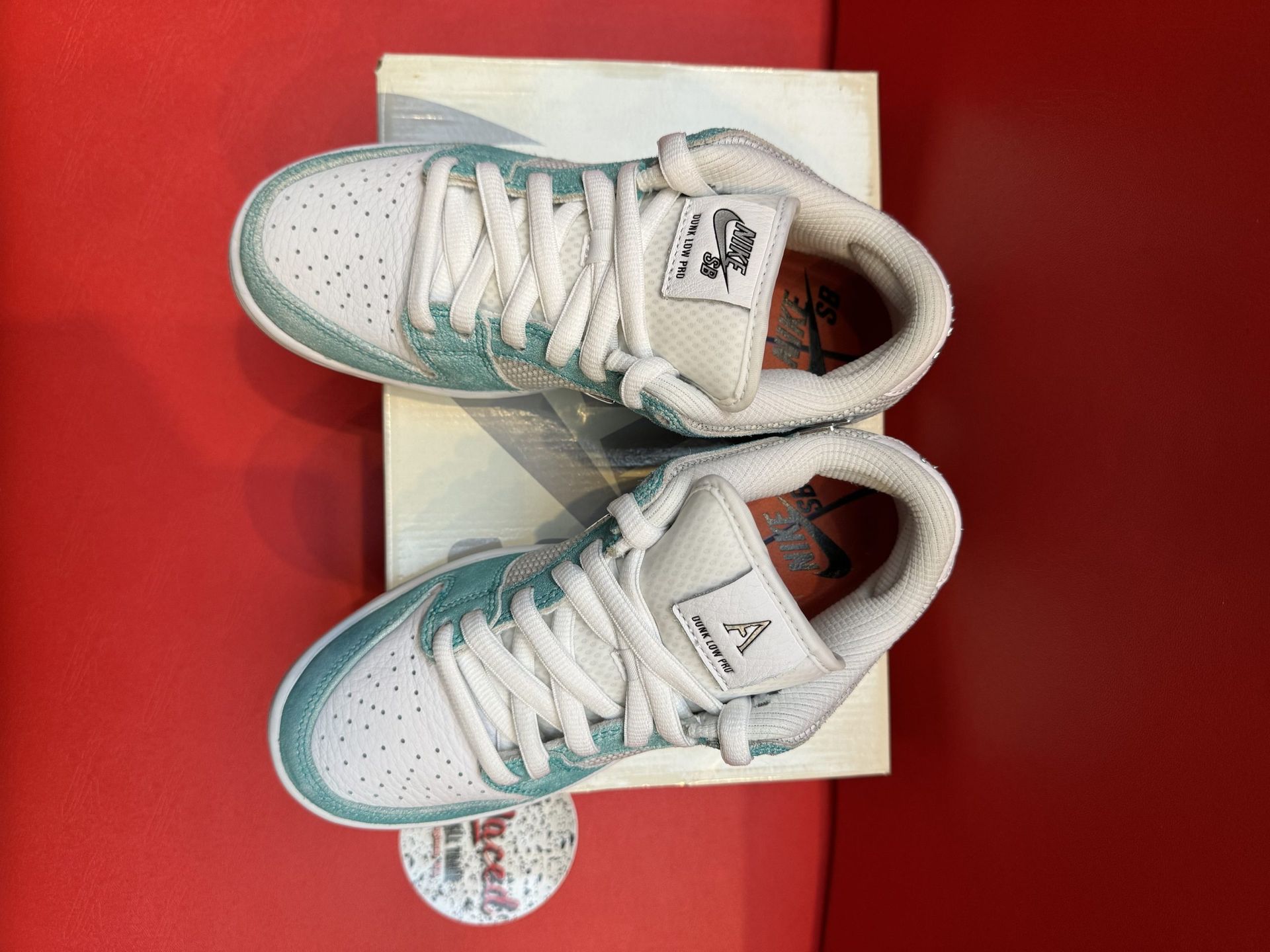 Nike SB Dunk Low sneakers with blue and white accents, on a shoe box.