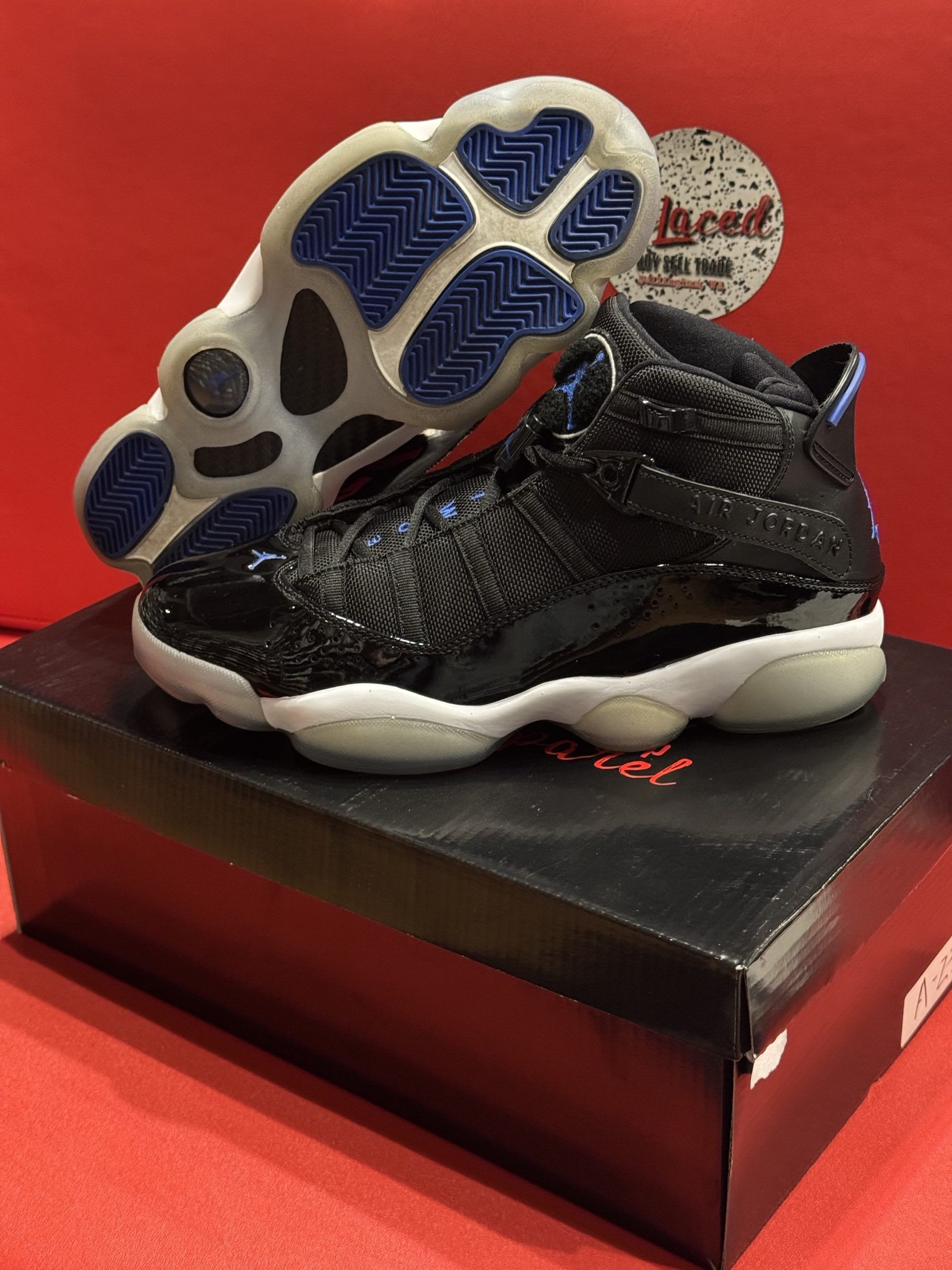 Black and blue sneakers on a shoe box, sole visible.