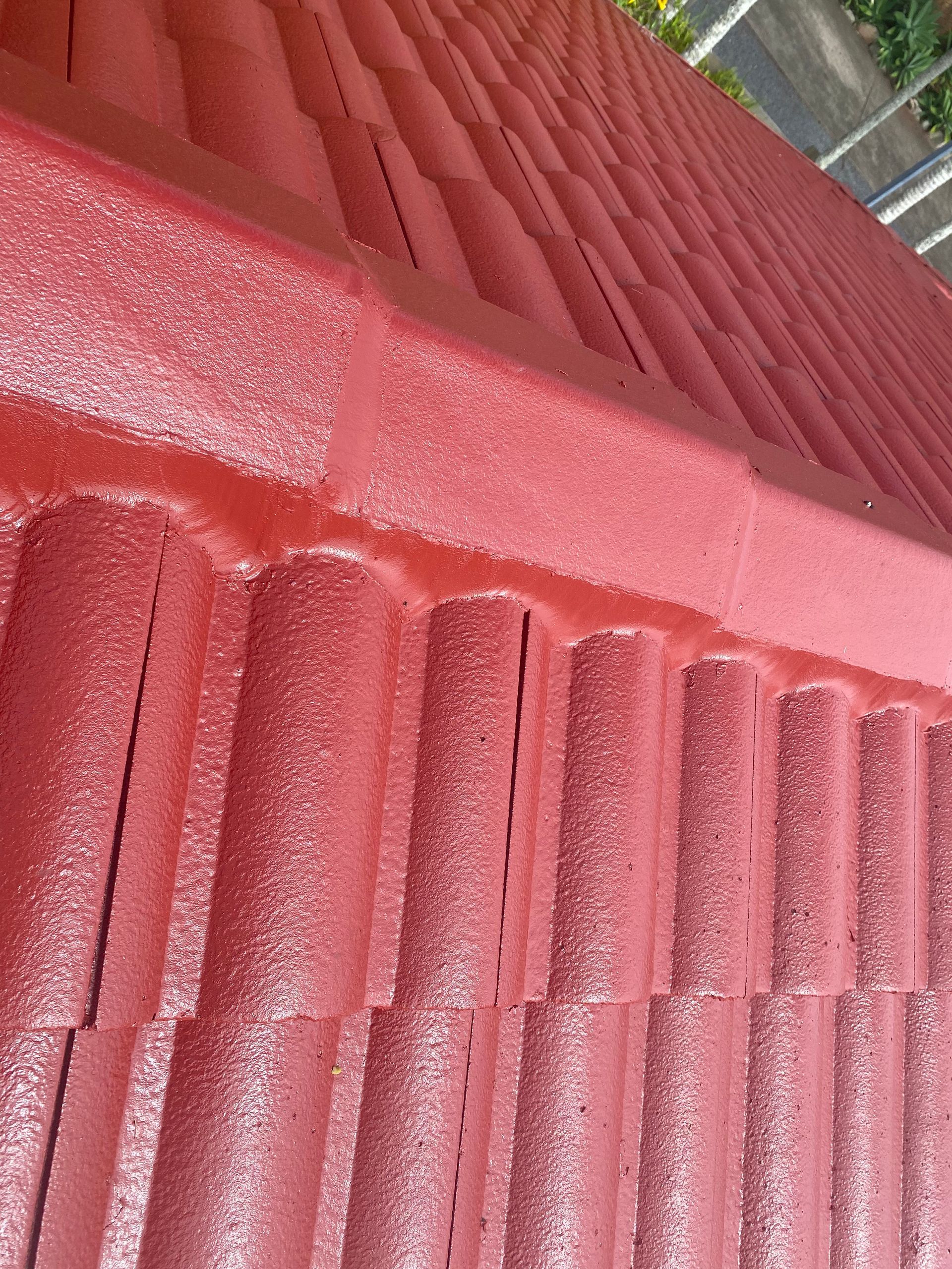 Red tiled roof, freshly painted, close-up view.