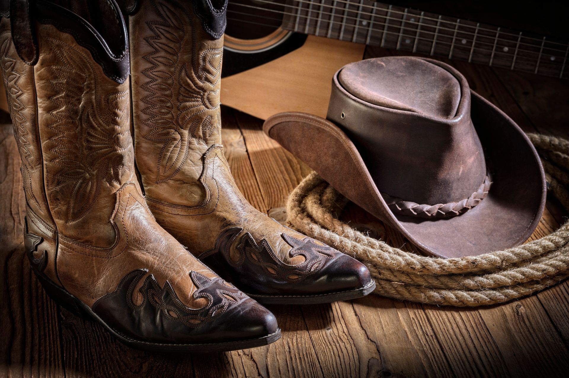 A woman in a cowboy hat is dancing at a party.