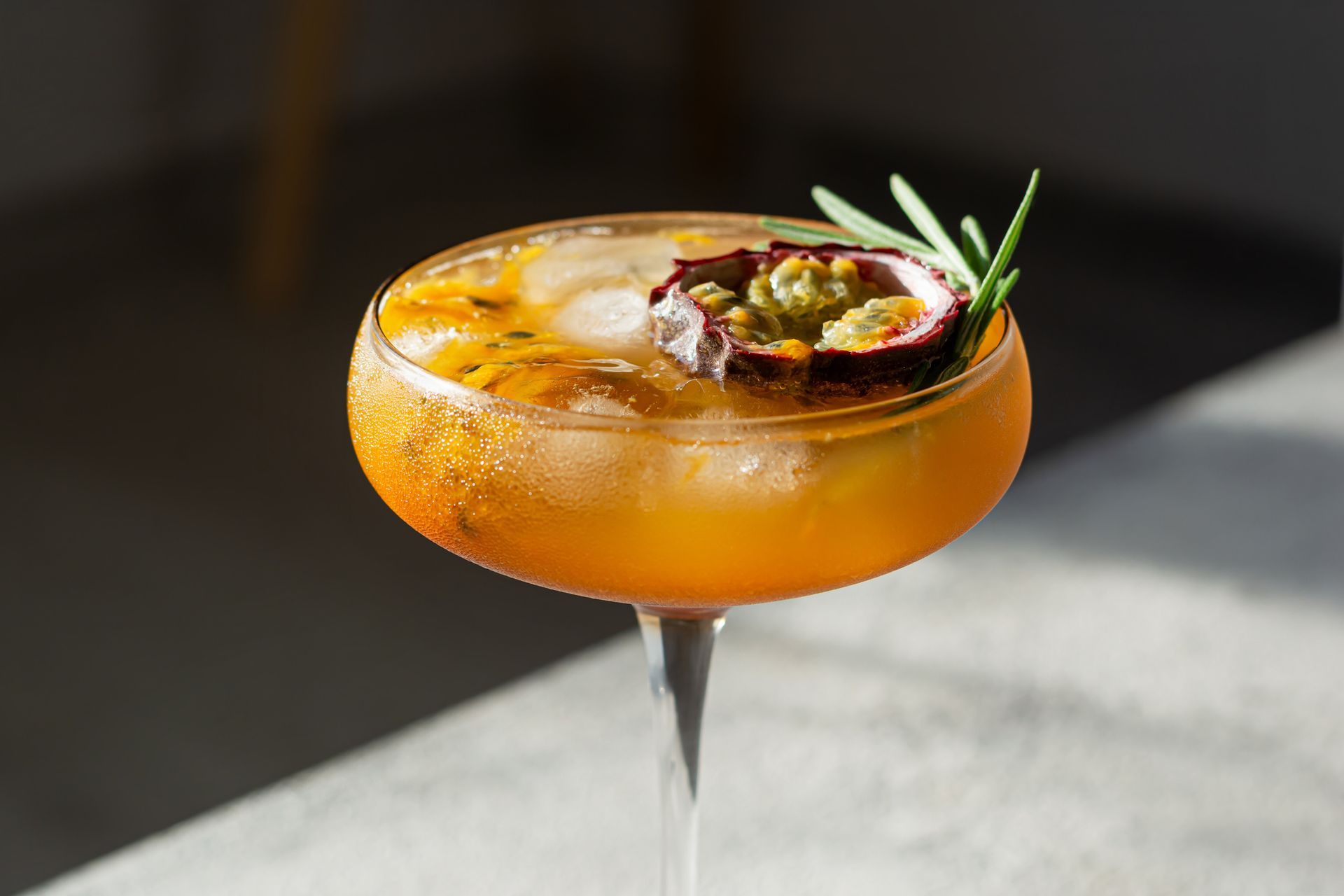 A close up of a cocktail in a martini glass on a table.