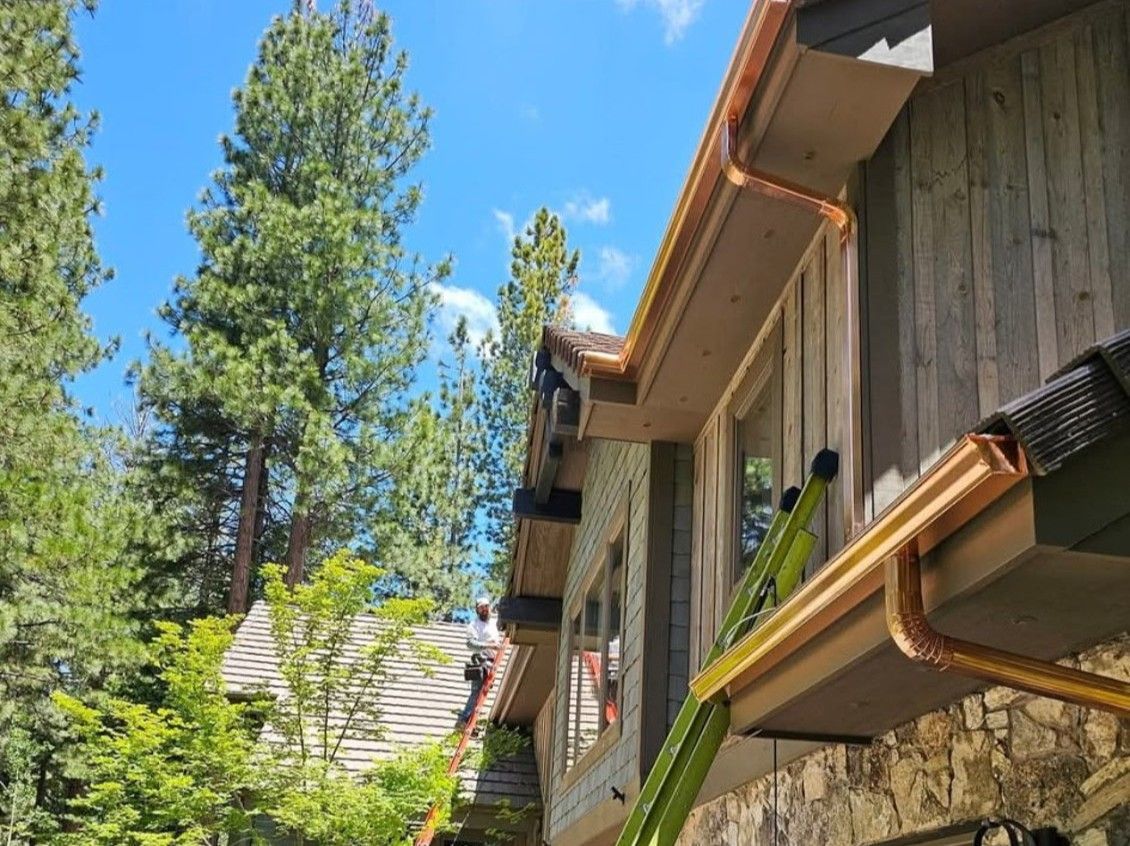 New seamless copper gutters being installed a new rustinc style Reno Home.