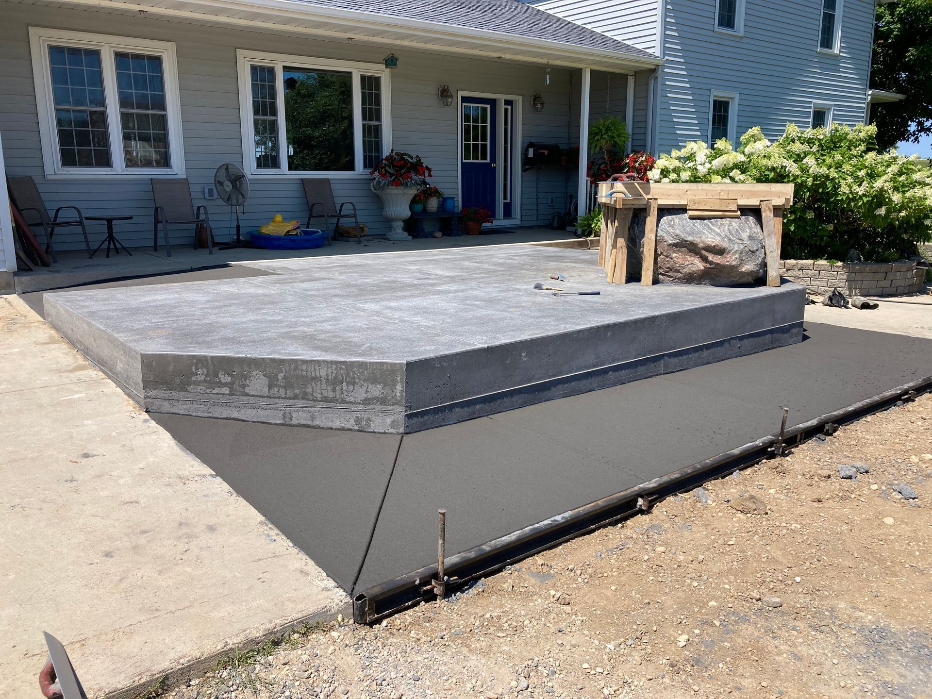 a concrete patio is being built in front of a house